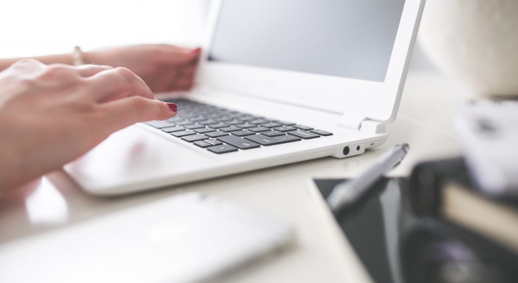 kaboompics.com_Closeup of woman hand typing on laptop keyboard